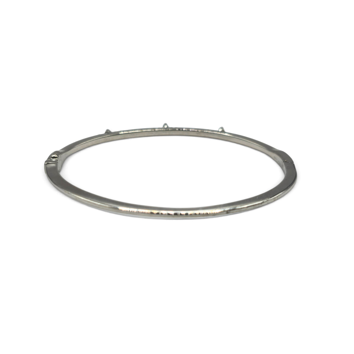 18ct white gold diamond bangle by Reeves and Sons with sparkling diamonds, showcasing a sleek and elegant jewelry design.