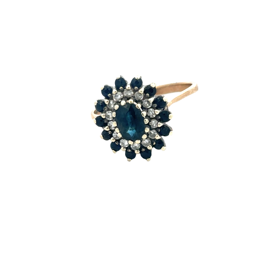 9ct yellow gold sapphire and diamond ring by Reeves and Sons, showcasing a central blue sapphire with sparkling diamonds.