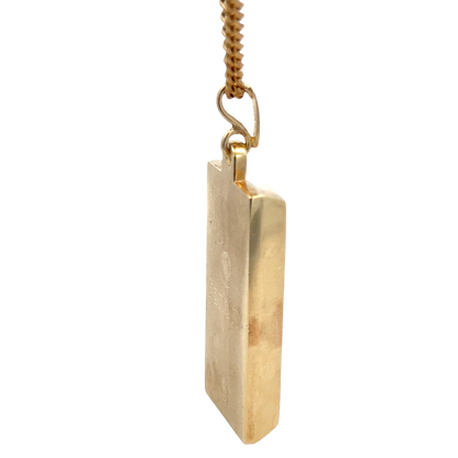 9ct yellow gold ingot pendant by Reeves and Sons, 34.2g, featuring a polished gold ingot design on a chain.