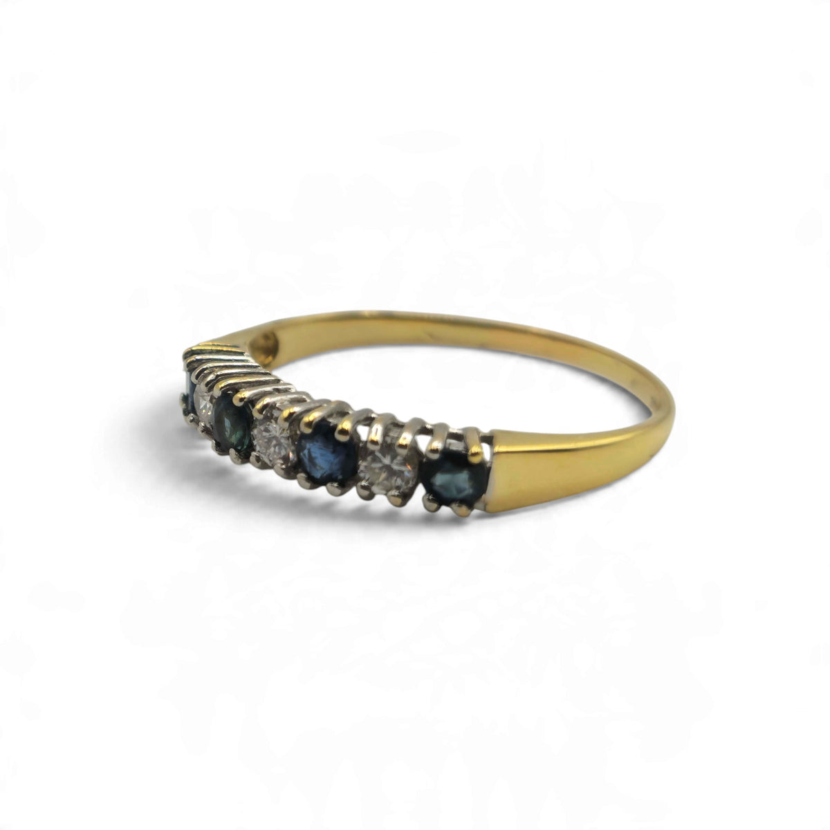 18ct yellow gold sapphire and diamond half eternity ring by Reeves and Sons, featuring alternating gemstones and a polished band.