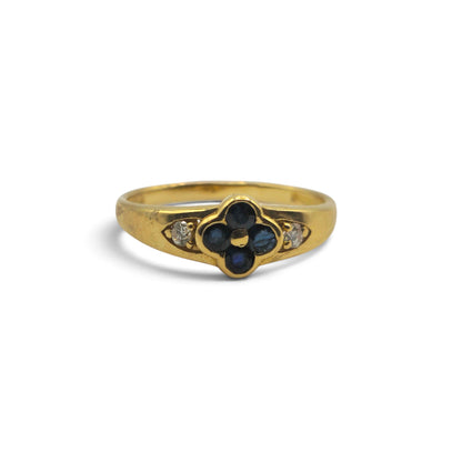 18ct yellow gold sapphire and diamond ring by Reeves and Sons, featuring a central sapphire and diamond accents