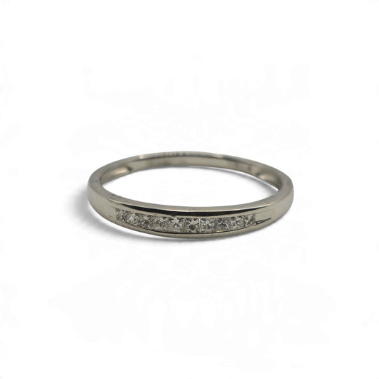 Platinum half eternity ring by Reeves and Sons, featuring a row of diamonds on the visible band