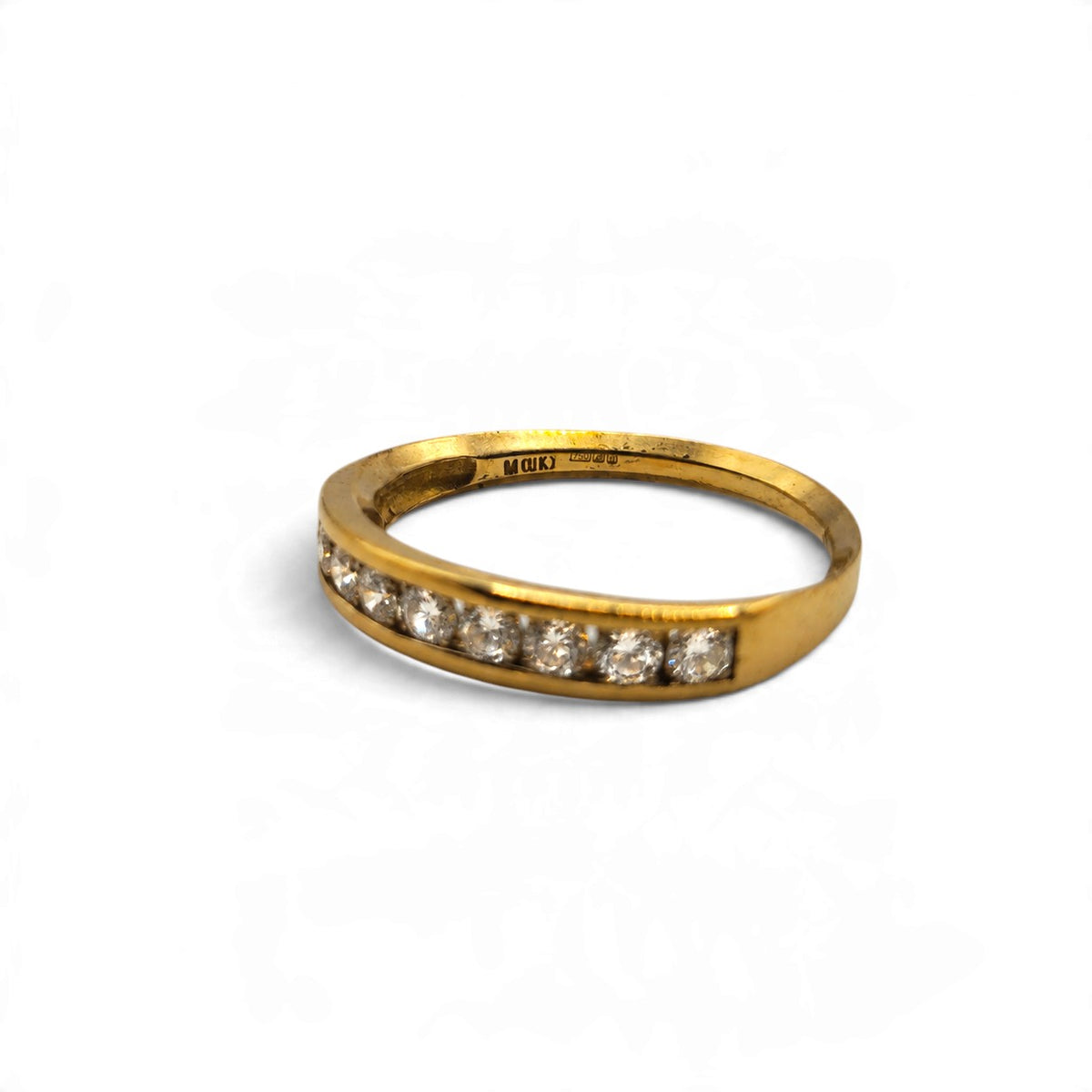 18ct yellow gold half eternity ring by Reeves and Sons, featuring a row of sparkling gemstones