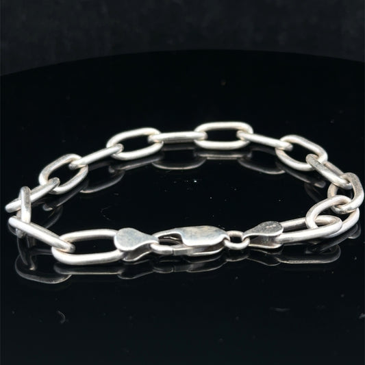 Silver chain bracelet by Reeves and Sons, 16.9g, featuring a sleek, polished design with interconnected links.