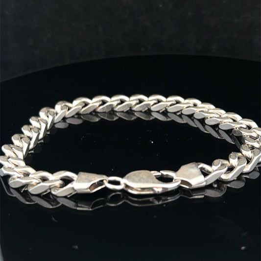 Silver curb bracelet by Reeves and Sons, 33.2g, showcasing interconnected curved links on a polished jewelry piece.