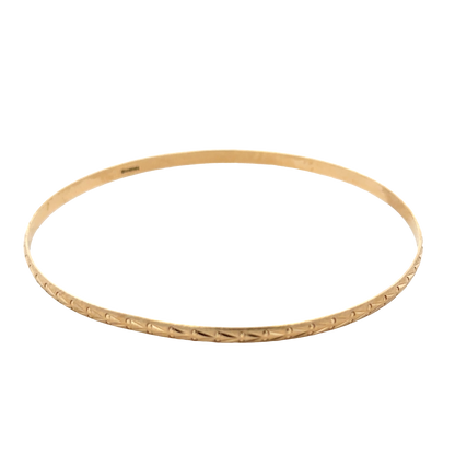 9ct yellow gold bangle by Reeves and Sons, lightweight jewelry piece weighing 4.2g, with a smooth, polished finish.