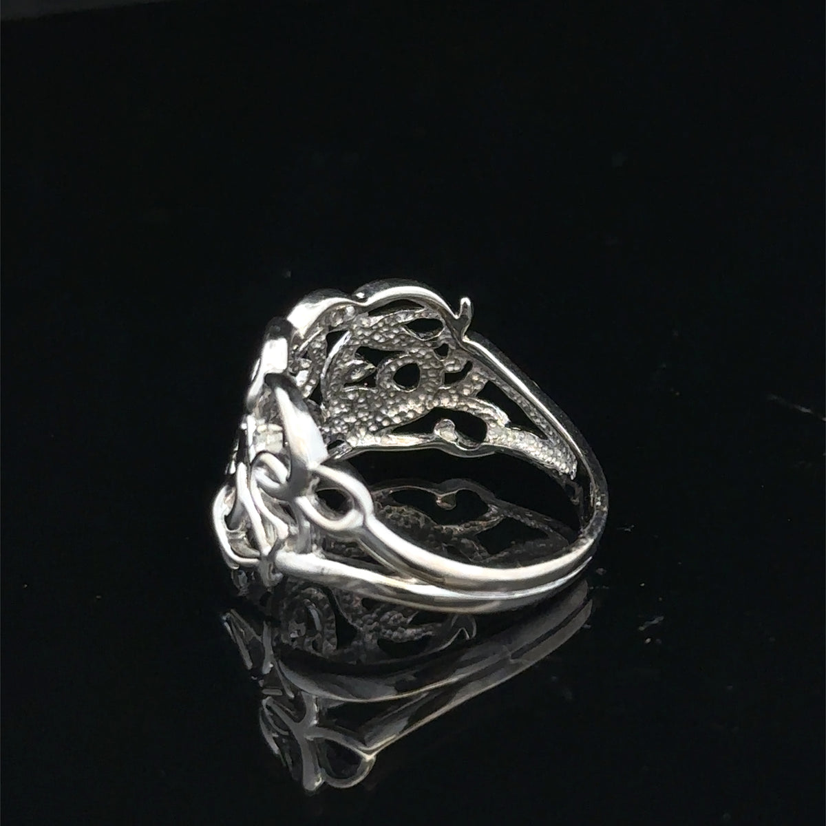 9ct white gold diamond ring size K1/2 featuring sparkling diamonds, crafted by Reeves and Sons, with intricate band details.