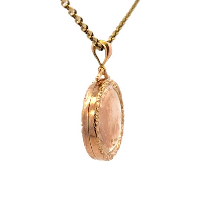 9ct yellow gold locket pendant by Reeves and Sons, featuring a polished, classic design with a secure bail attachment.