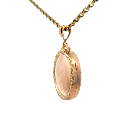 Reeves and Sons 9ct yellow gold locket pendant, 7.5g, featuring intricate engraved design and a polished finish.