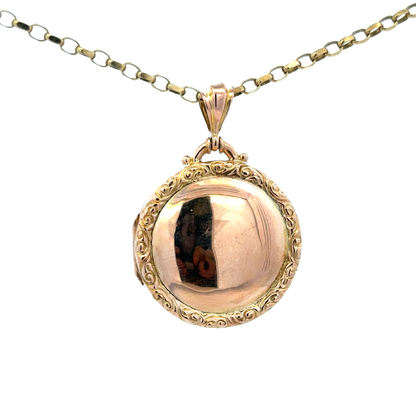 Reeves and Sons 9ct yellow gold locket pendant, 7.5g, featuring a smooth oval design with intricate detailing on the front.