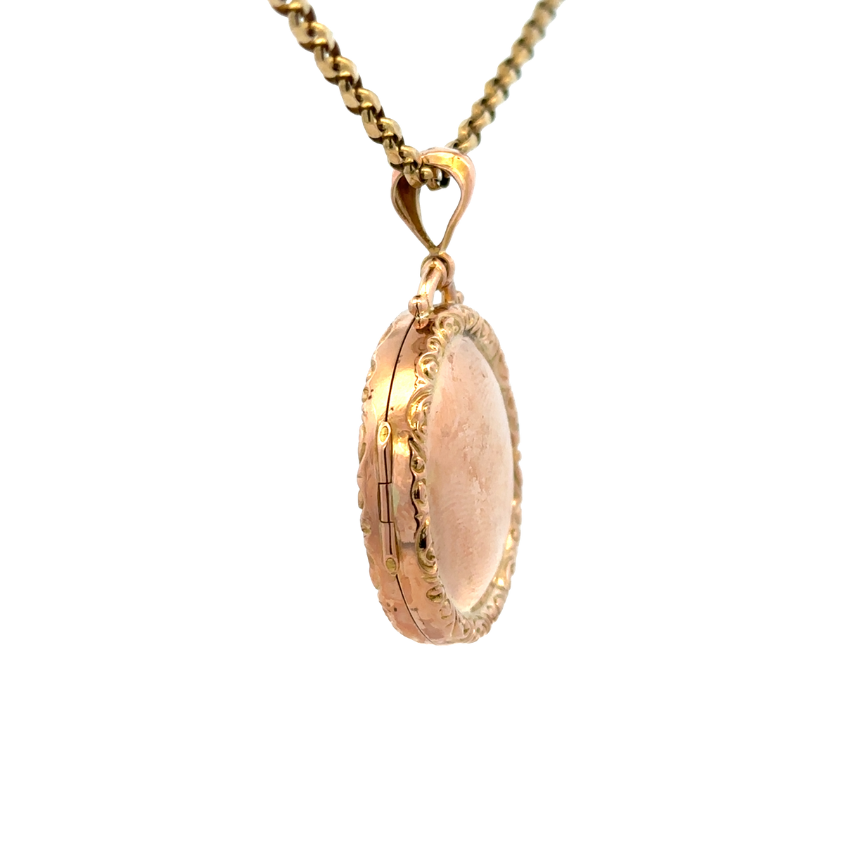 9ct yellow gold locket pendant with detailed engraved design, weight 7.5g, by Reeves and Sons, shown close-up in the image.