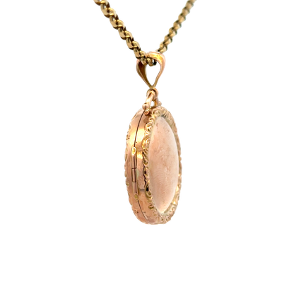 9ct yellow gold locket pendant with detailed engraved design, weight 7.5g, by Reeves and Sons, shown close-up in the image.