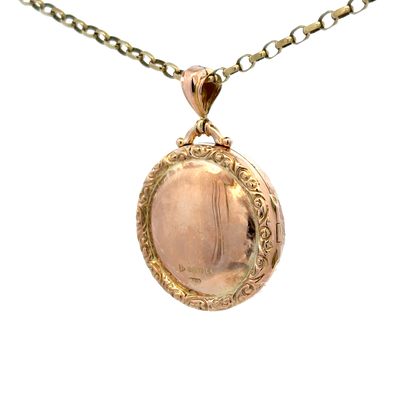 9ct yellow gold locket pendant by Reeves and Sons, featuring a polished surface and delicate design, weighs 7.5 grams.