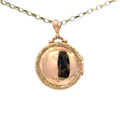 9ct yellow gold locket pendant with intricate design, weight 7.5g, by Reeves and Sons, displayed against a neutral background.