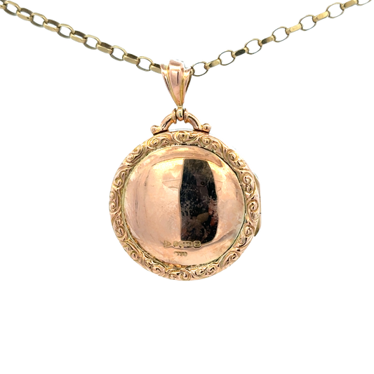 9ct yellow gold locket pendant with intricate design, weight 7.5g, by Reeves and Sons, displayed against a neutral background.
