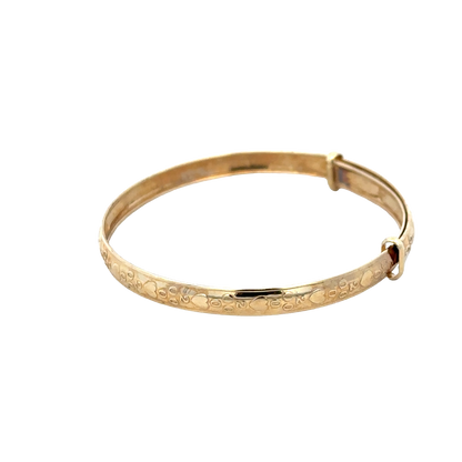 9ct yellow gold baby bangle weighing 2g with simple, smooth design from Reeves and Sons, shown in close-up.