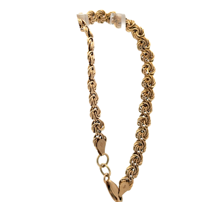 9ct yellow gold bracelet by Reeves and Sons, 4.8g, with intricate link design, shown in close-up image.