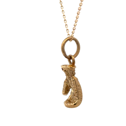 9ct yellow gold boxing glove pendant by Reeves and Sons, 5g, showing detailed boxing glove design on a plain background.