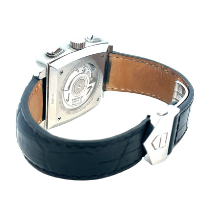 Tag Heuer Monaco automatic chronograph watch with black dial and stainless steel case, displayed on a white background.