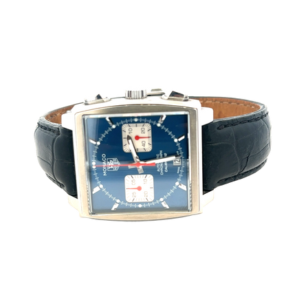 Reeve and Sons Tag Heuer Monaco automatic chronograph watch with black dial, silver case, and leather strap.