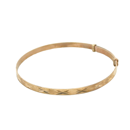 9ct yellow gold baby bangle by Reeves and Sons, delicate jewelry piece with a smooth, polished finish and lightweight design.