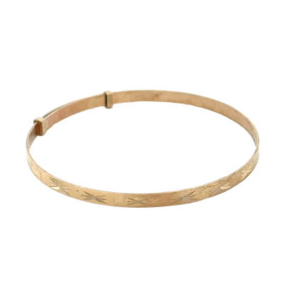 9ct yellow gold baby bangle with delicate design, weighing 1.8g, from Reeves and Sons.