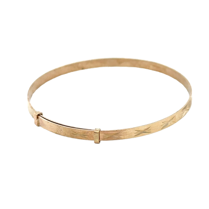 9ct yellow gold baby bangle weighing 1.8g, crafted by Reeves and Sons, with a smooth, rounded design for infants.