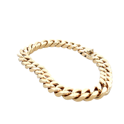 9ct yellow gold curb bracelet by Reeves and Sons, 53.4g, shown on a plain background