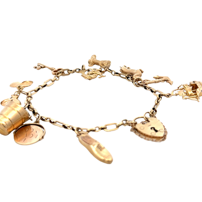 9ct yellow gold charm bracelet by Reeves and Sons, 16.3g, displayed on a plain background