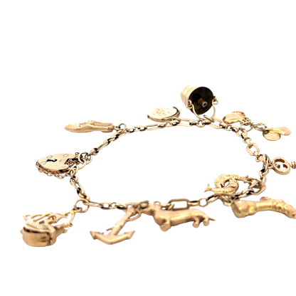 9ct yellow gold charm bracelet by Reeves and Sons, 16.3g weight, featuring assorted charms