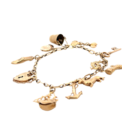 9ct yellow gold charm bracelet by Reeves and Sons, 16.3g, featuring multiple dangling charms