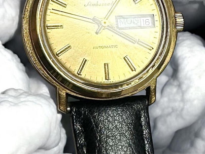 Bulova plated automatic watch with a sleek design, weighing 44.9 grams, displayed on a plain background.