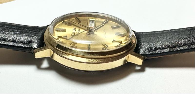 Bulova plated automatic watch with stainless steel case, featuring a sleek design and a 44.9g weight.