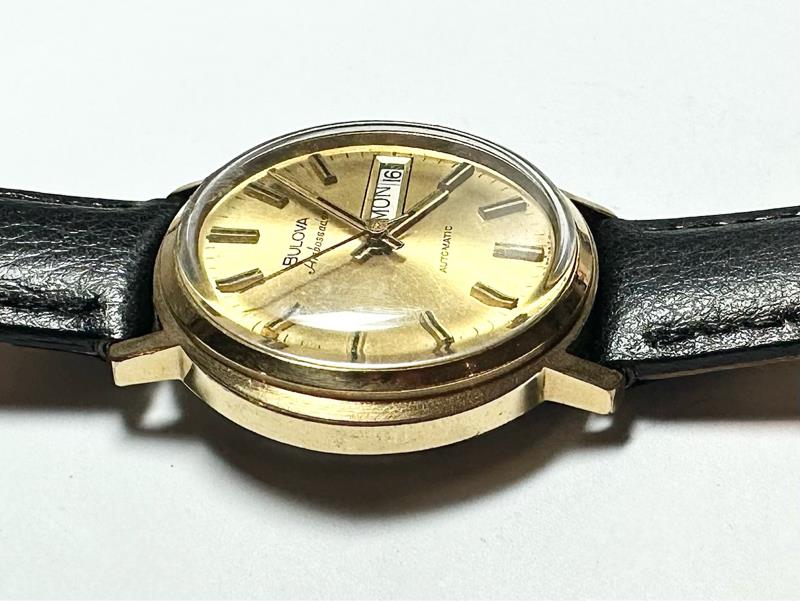 Bulova plated automatic watch with a sleek design, weighing 44.9g, featuring a polished finish and classic timepiece details.