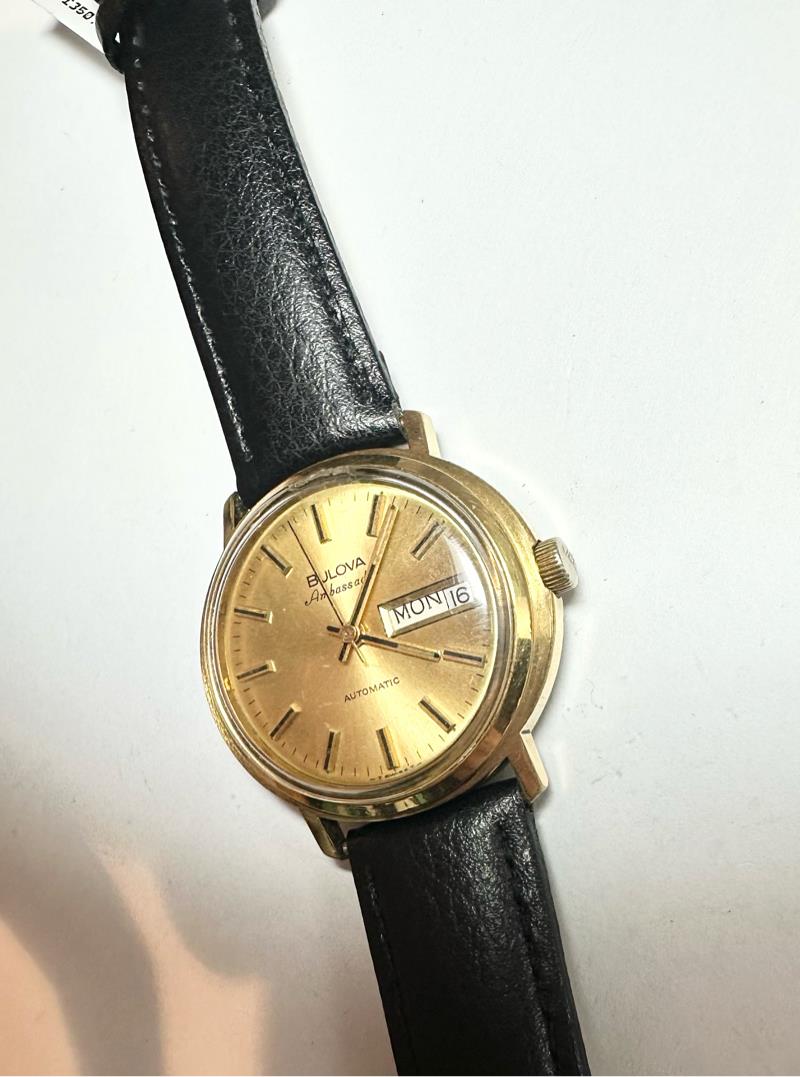 Bulova plated automatic watch with a sleek design, weighing 44.9 grams, displayed on a neutral background.
