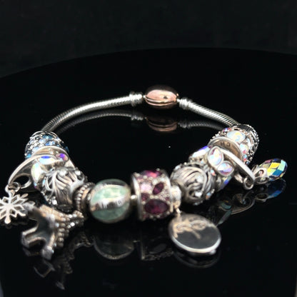 925 silver Chamilia charm bracelet featuring decorative charms and intricate details on a sleek silver chain.