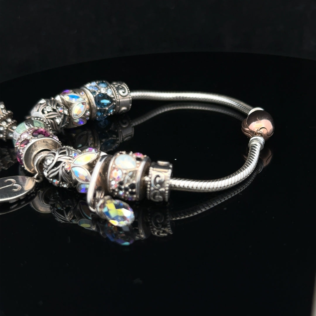 925 silver Chamilia charm bracelet with decorative charms, showcasing intricate details and elegant design.