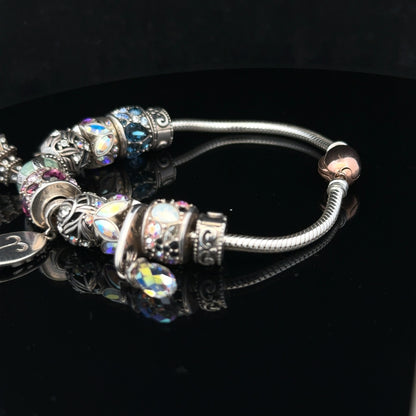925 silver Chamilia charm bracelet with decorative charms, showcasing intricate details and elegant design.