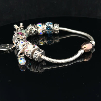 925 silver Chamilia charm bracelet with multiple charms and intricate details, showcasing elegant jewelry craftsmanship.