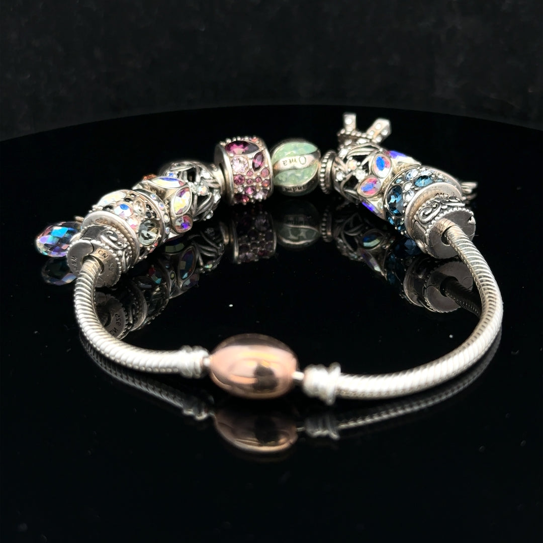 925 silver Chamilia charm bracelet with intricate charms and clasp, showcasing high-quality craftsmanship and elegant design.
