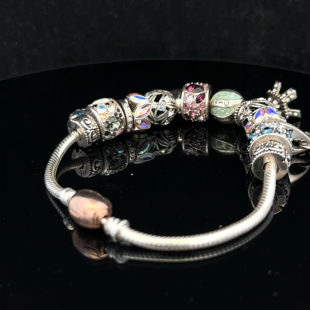 925 silver Chamilia charm bracelet featuring multiple engraved charms on a delicate chain.