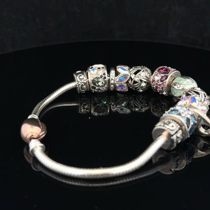 925 silver Chamilia charm bracelet featuring detailed charms and a secure clasp, showcasing elegant craftsmanship and design.