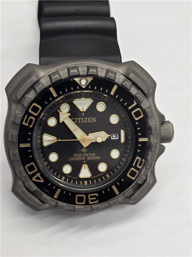 Citizen Eco-Drive titanium divers watch with black dial and rotating bezel, featuring luminous hands and stainless steel bracelet.