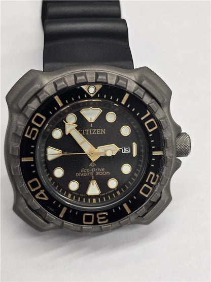 Citizen Eco-Drive titanium divers watch with black dial and rotating bezel, featuring luminous hands and stainless steel bracelet.