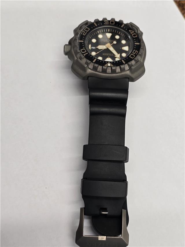Citizen Eco-Drive titanium divers watch with black dial and stainless steel band, featuring a rotating bezel and luminous markers.