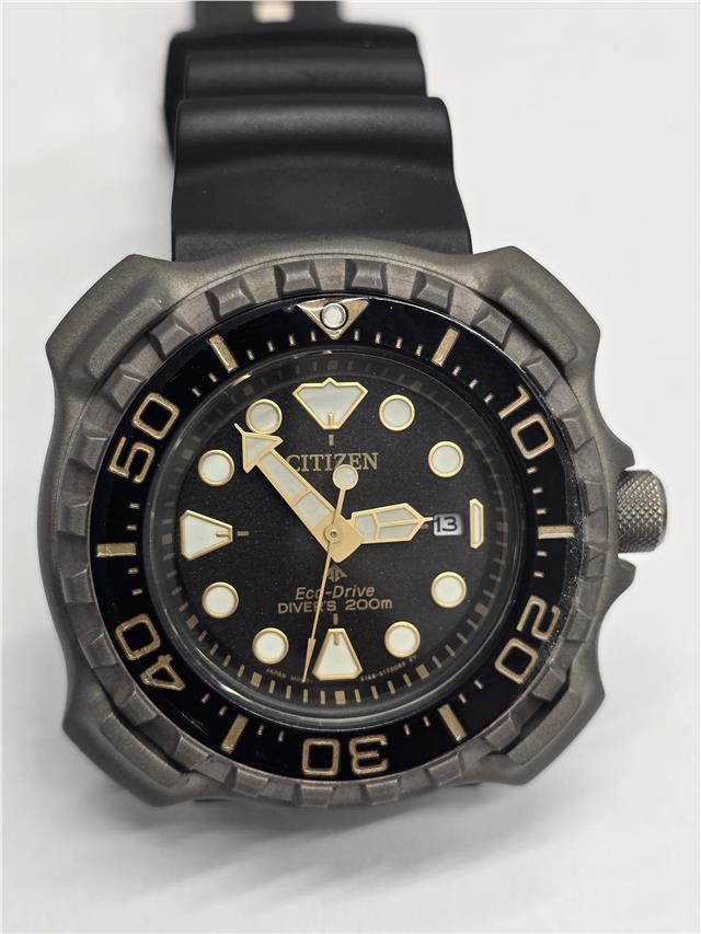 Citizen Eco-Drive titanium divers watch with black dial, stainless steel band, and unidirectional bezel.