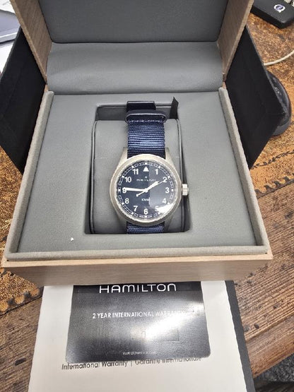 Hamilton Khaki Watch Age 2025 with black dial and stainless steel bracelet, detailed close-up of the watch face.