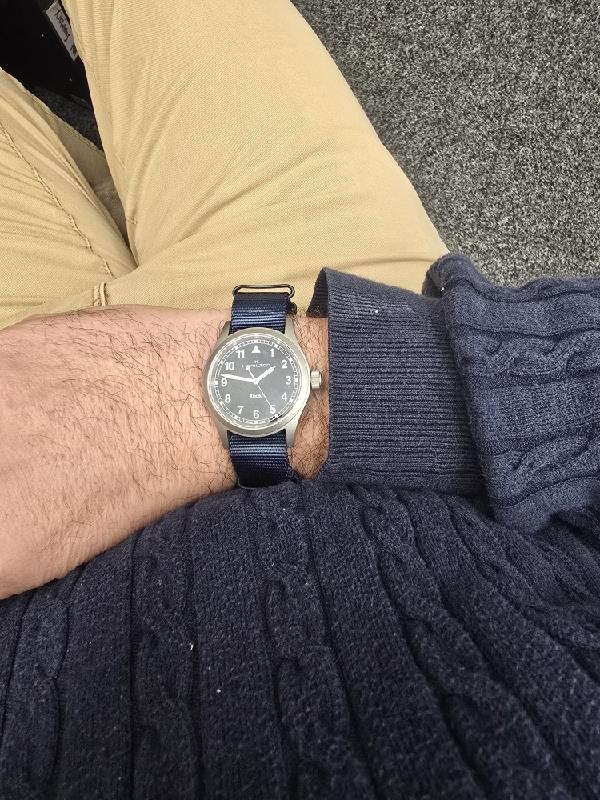 Hamilton Khaki watch Age 2025 with black dial and stainless steel strap, showcasing a sleek, modern design.
