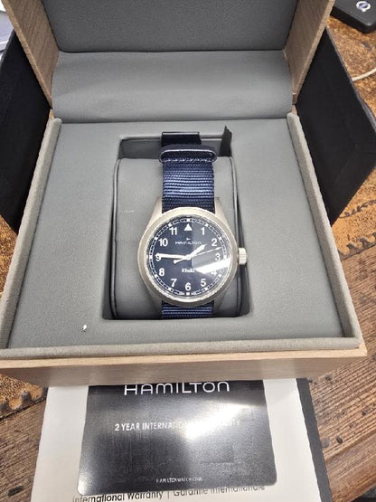 Hamilton Khaki Watch Age 2025 with black dial, stainless steel case, and adjustable strap, designed for a classic, military-inspired look.