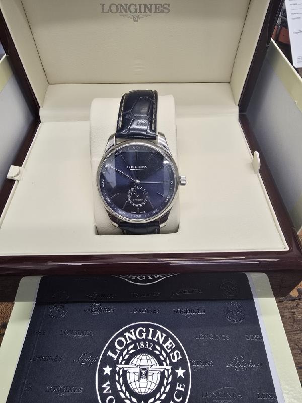 Longines Master Collection watch with boxed papers, featuring a stainless steel case and classic dial design.